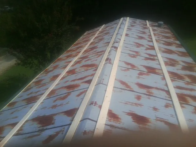 Rusted metal roof panels with new wood purlins before replacement — Storm Damage Roof Repair in Morris Plains by Roofing Brothers