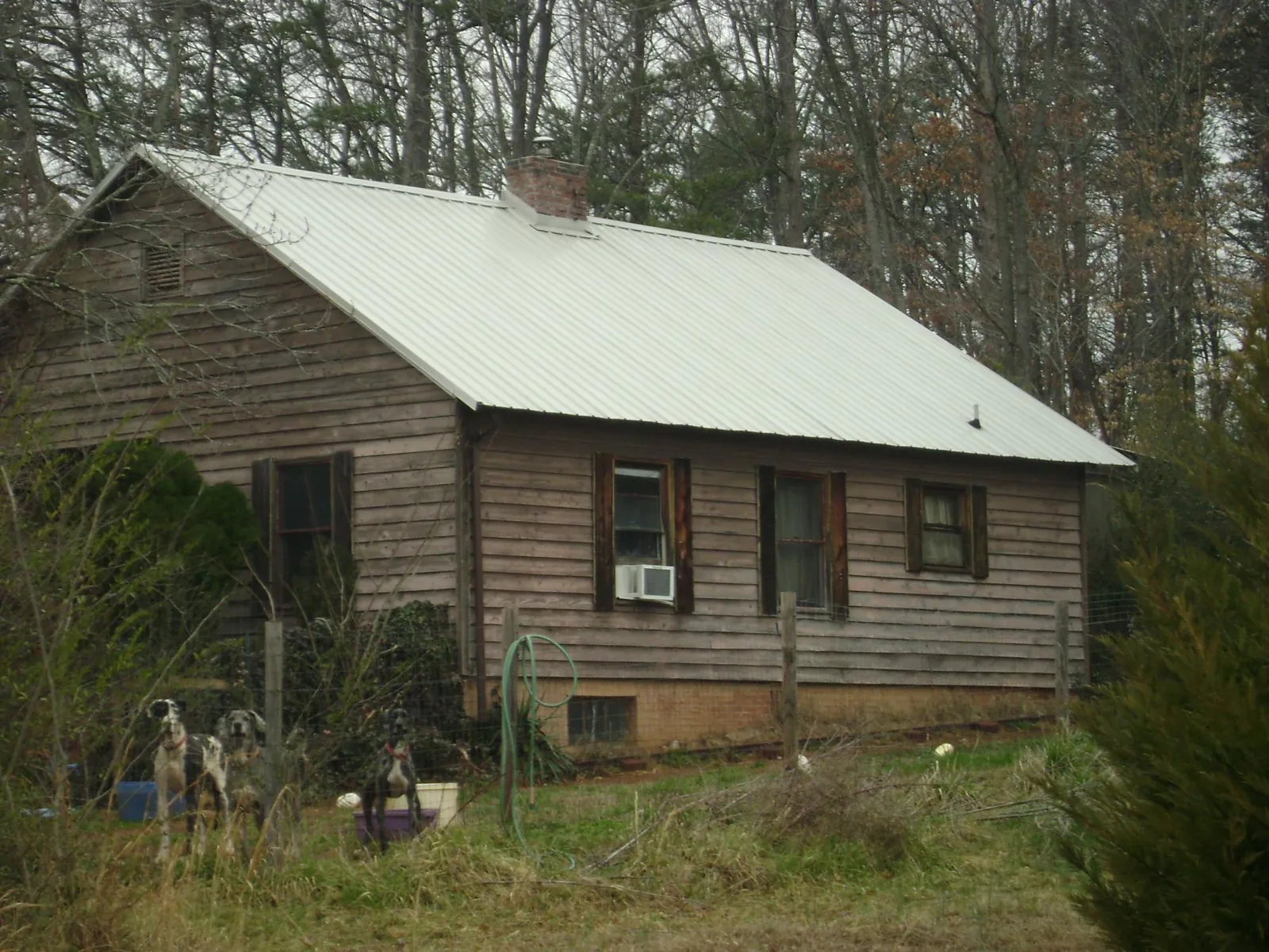 White metal roof on an old wood sided farmhouse, from a Metal Roof Installation job in Morris Plains